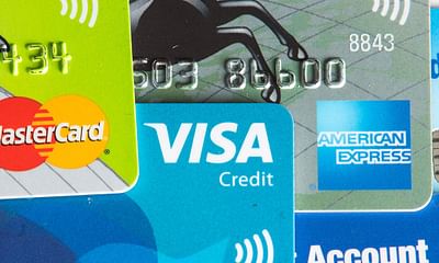 How do credit card companies make money from credit cards that offer cashback?